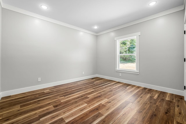 unfurnished room with dark hardwood / wood-style flooring and crown molding