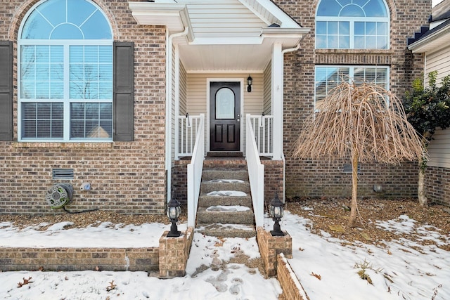 view of snow covered property entrance