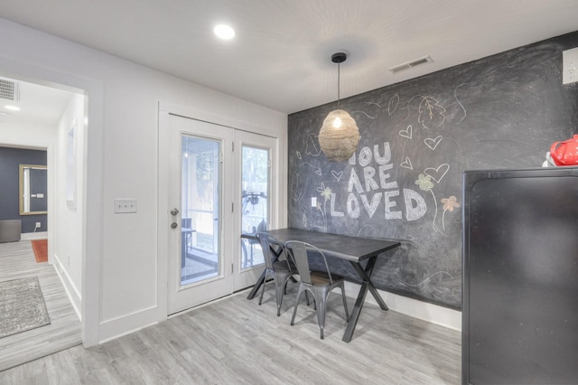 dining space featuring a wealth of natural light and hardwood / wood-style flooring