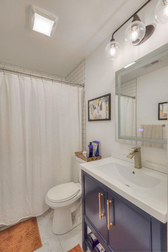 bathroom featuring toilet and vanity