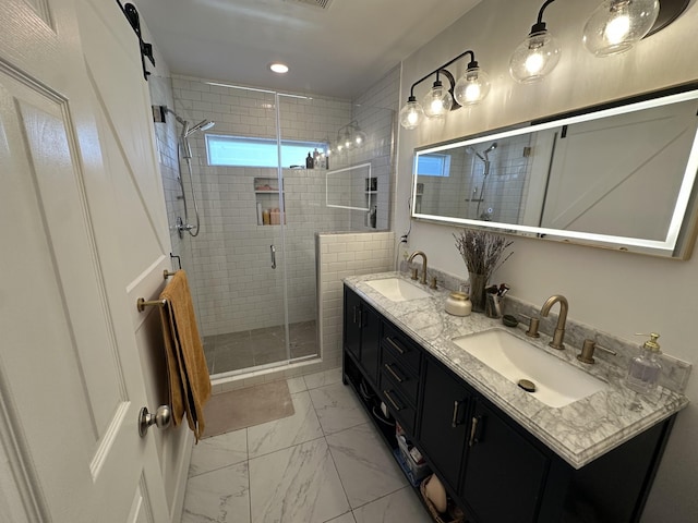 bathroom with vanity and a shower with door