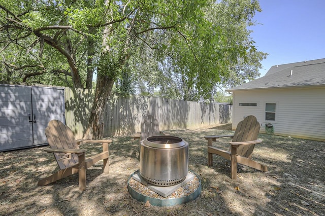 view of yard with a fire pit