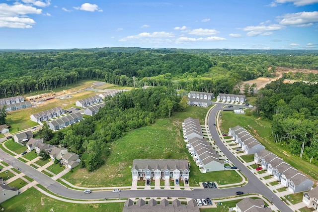 drone / aerial view with a residential view and a view of trees