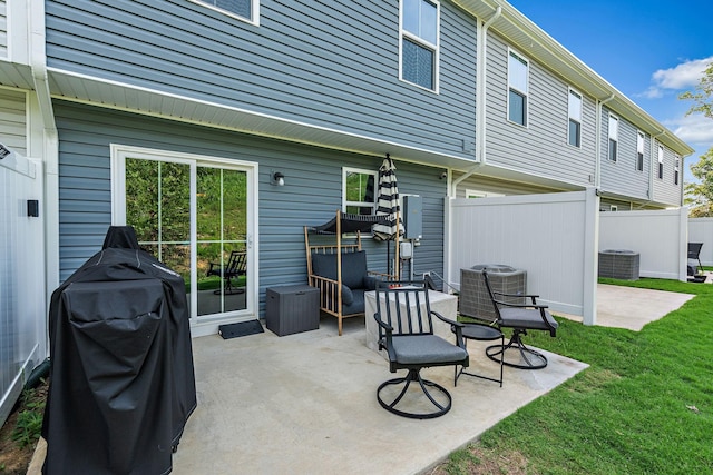 rear view of property with a yard, cooling unit, a patio, and fence