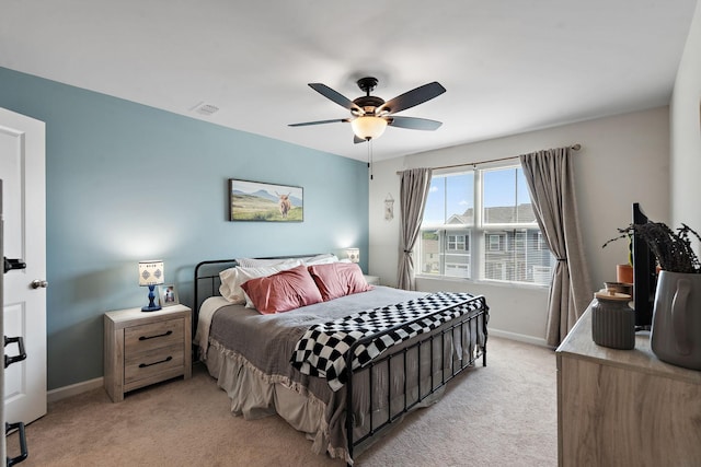 bedroom with light carpet, baseboards, visible vents, and a ceiling fan