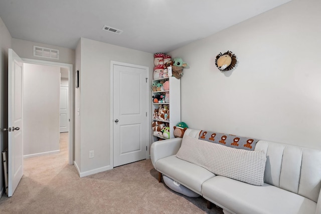 living room with baseboards, visible vents, and light colored carpet