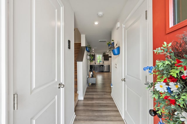 corridor featuring baseboards, visible vents, wood finished floors, and recessed lighting