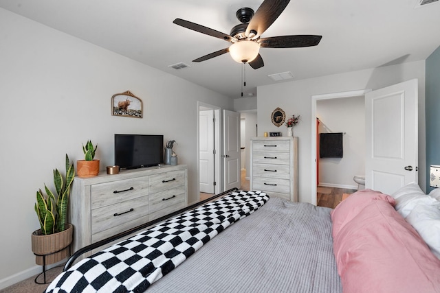 bedroom featuring baseboards, visible vents, ceiling fan, and connected bathroom