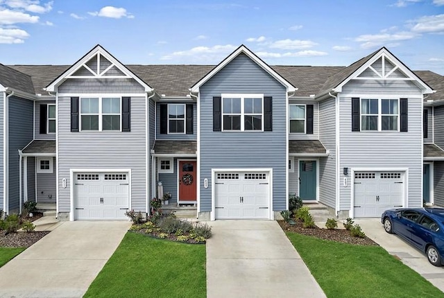 view of property with an attached garage and concrete driveway