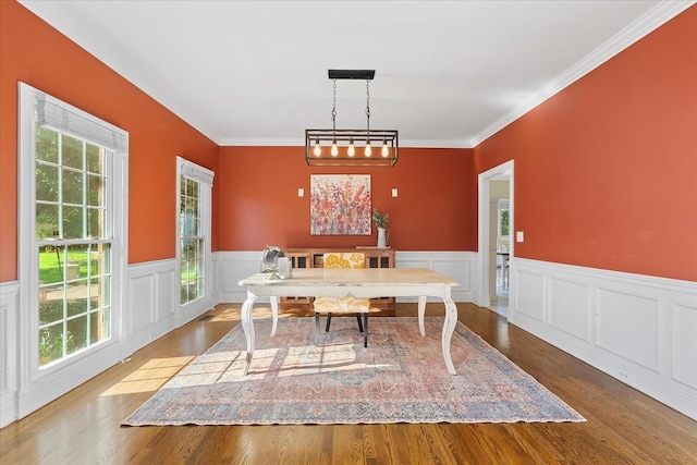 dining room with ornamental molding and hardwood / wood-style flooring