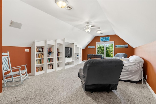 carpeted bedroom with ceiling fan and vaulted ceiling