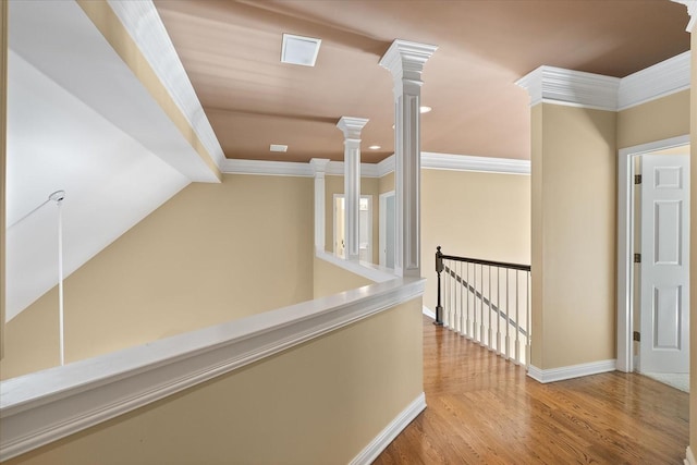 corridor featuring ornamental molding, lofted ceiling, and light hardwood / wood-style flooring