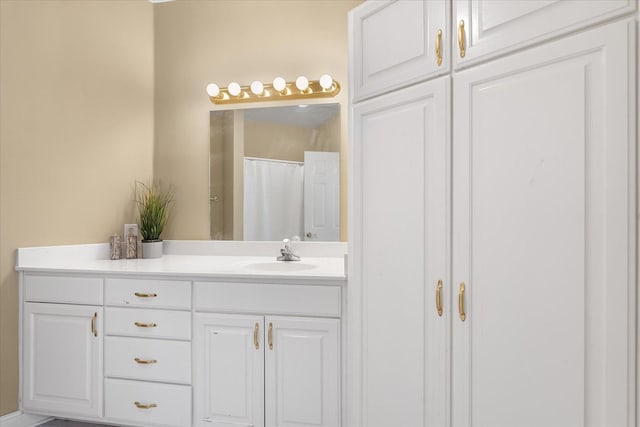 bathroom with walk in shower and vanity