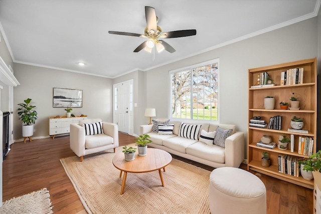 living room with ornamental molding, ceiling fan, and dark hardwood / wood-style flooring