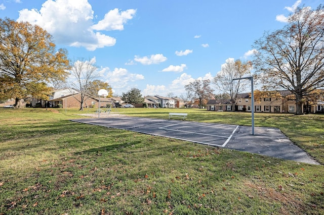 view of sport court with community basketball court, a residential view, and a yard