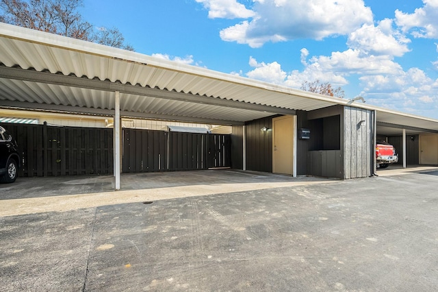 covered parking lot with fence