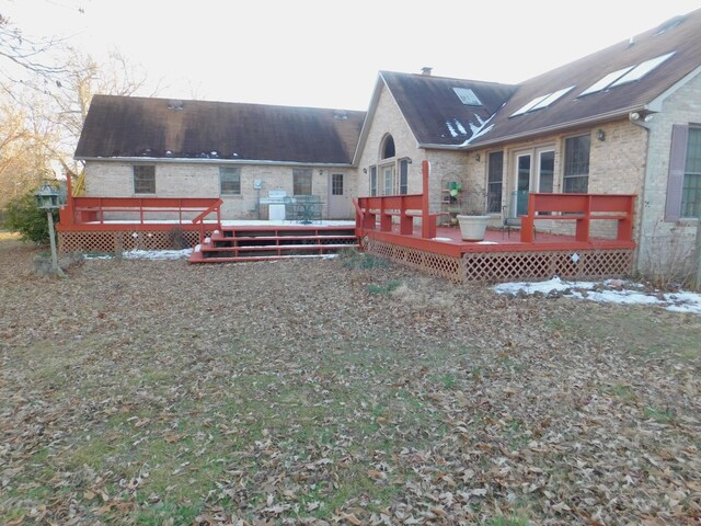 rear view of property with a deck