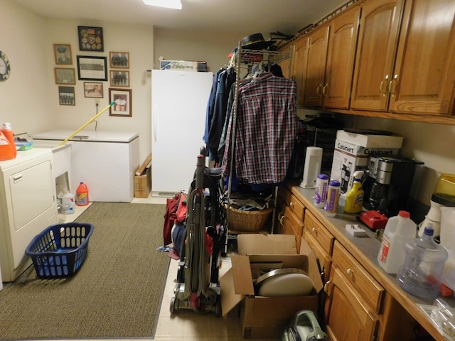 interior space featuring washing machine and clothes dryer and cabinets