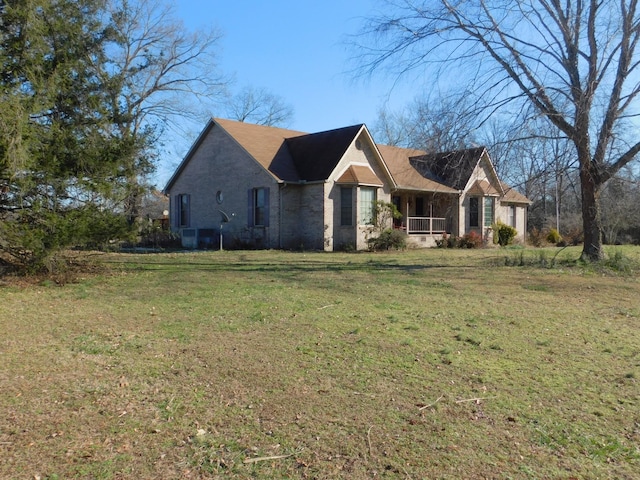 view of home's exterior featuring covered porch and a lawn