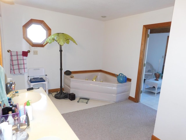 bathroom with a tub and vanity