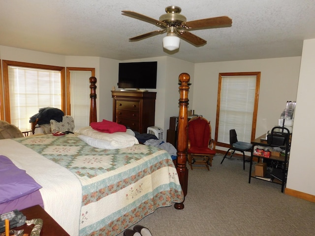 bedroom featuring ceiling fan, a textured ceiling, and light carpet