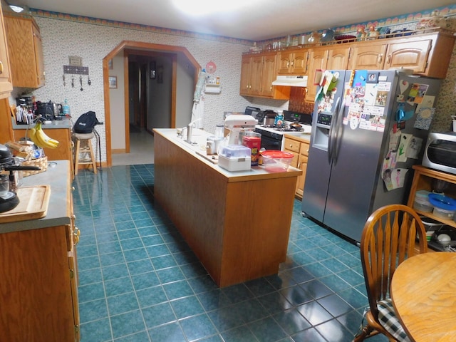 kitchen with a kitchen island and appliances with stainless steel finishes