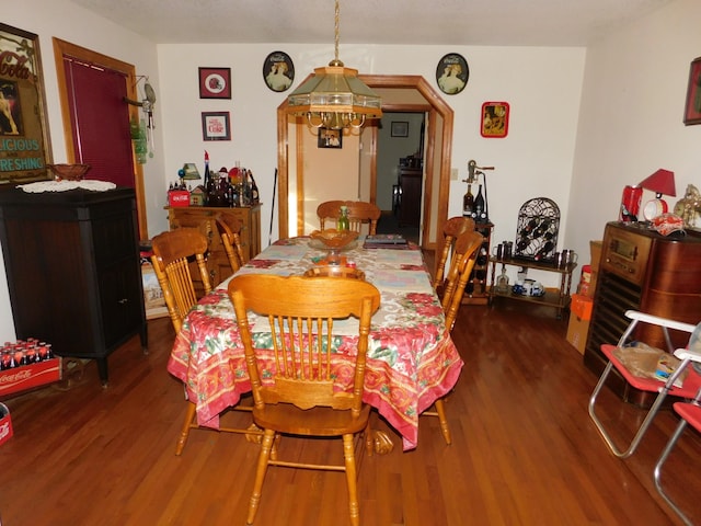 dining space featuring a notable chandelier and hardwood / wood-style flooring