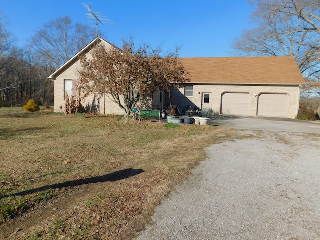 view of front of house with a garage and a front lawn