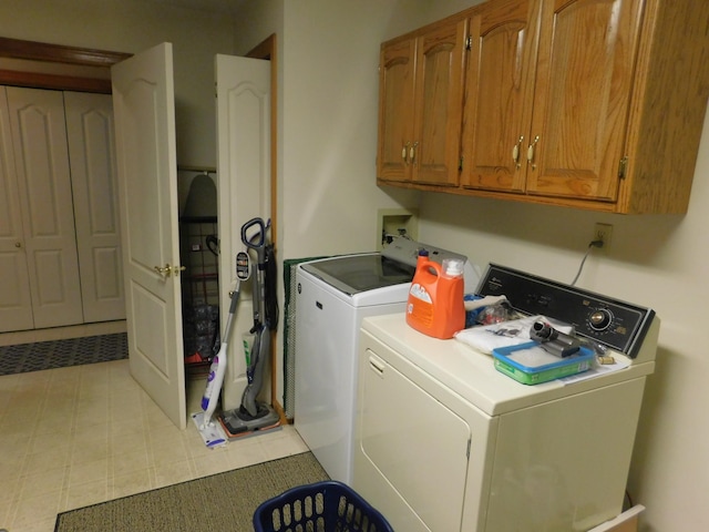 washroom with cabinets and separate washer and dryer