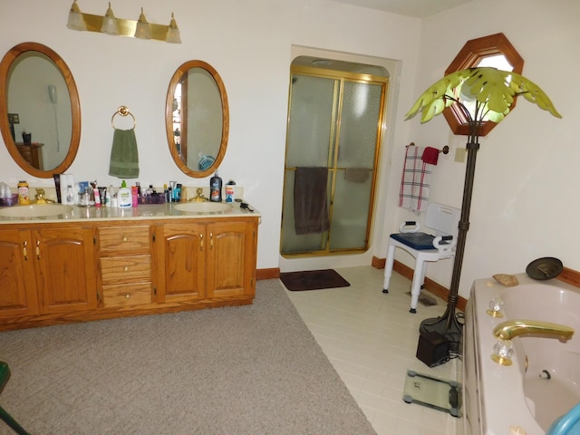 bathroom with tile patterned floors, vanity, and shower with separate bathtub