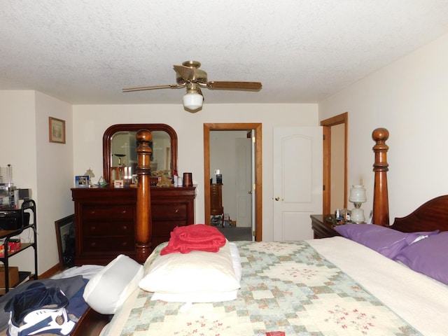 bedroom with ceiling fan and a textured ceiling