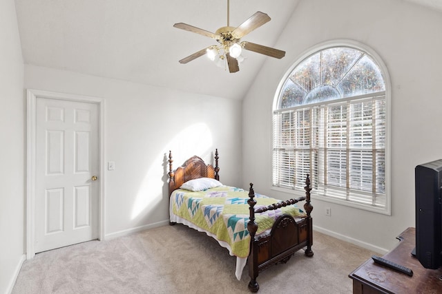 carpeted bedroom with ceiling fan, multiple windows, and lofted ceiling