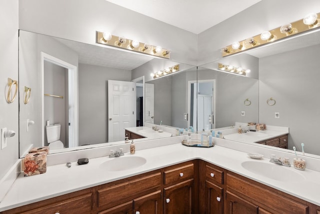 bathroom with toilet and vanity