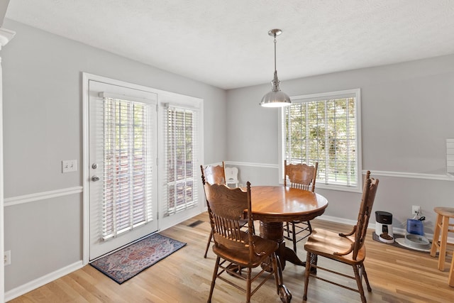 dining area with light hardwood / wood-style floors