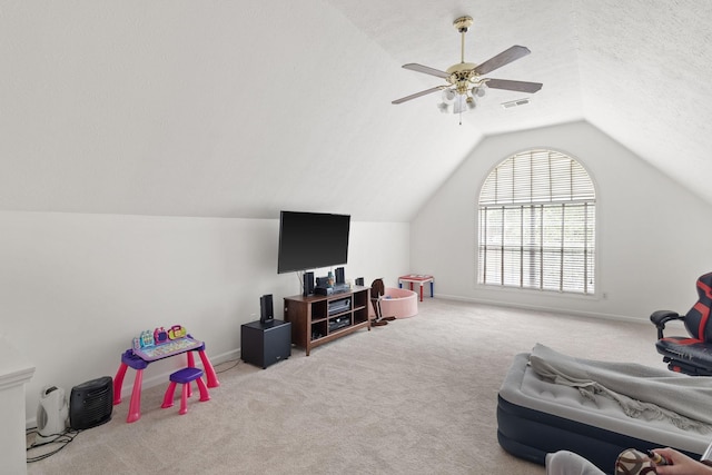 rec room featuring ceiling fan, light colored carpet, a textured ceiling, and vaulted ceiling