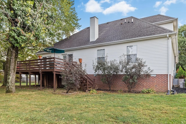 back of house featuring a wooden deck and a yard