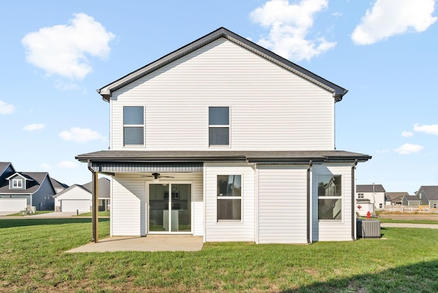 rear view of property with ceiling fan, cooling unit, a lawn, and a patio