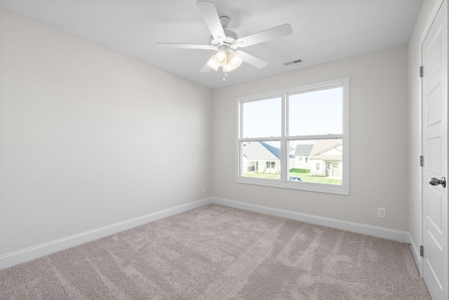 carpeted empty room featuring ceiling fan