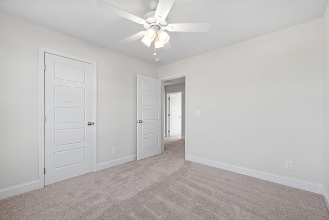 unfurnished bedroom featuring ceiling fan and light colored carpet