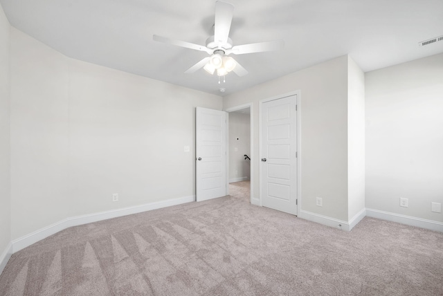 unfurnished bedroom with ceiling fan and light colored carpet