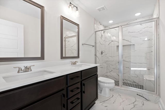 bathroom featuring toilet, a shower with door, and vanity