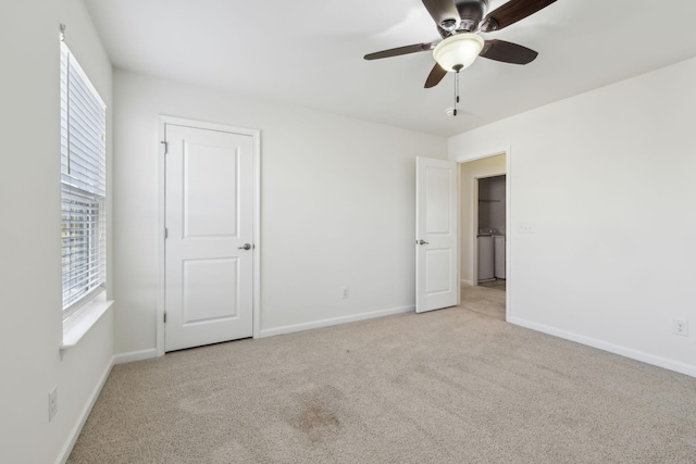 unfurnished bedroom with ceiling fan, light colored carpet, and multiple windows