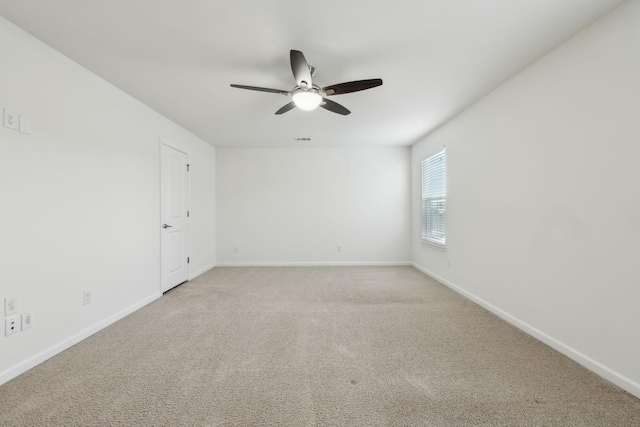 spare room featuring ceiling fan and carpet flooring