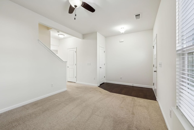 carpeted empty room with ceiling fan