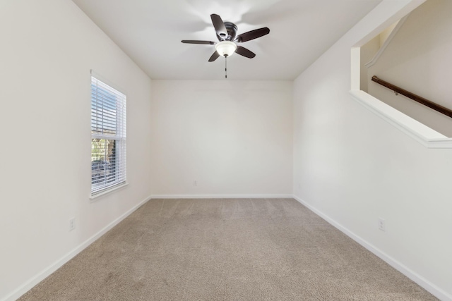 spare room featuring ceiling fan and carpet flooring