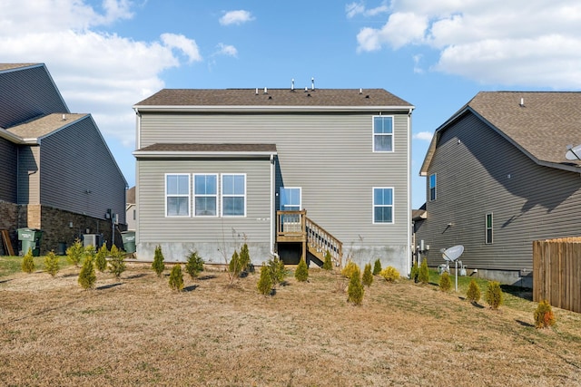 back of property featuring a yard and central AC unit