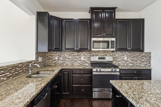 kitchen with backsplash, dark hardwood / wood-style floors, sink, and stainless steel appliances