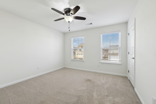 spare room featuring ceiling fan and light colored carpet