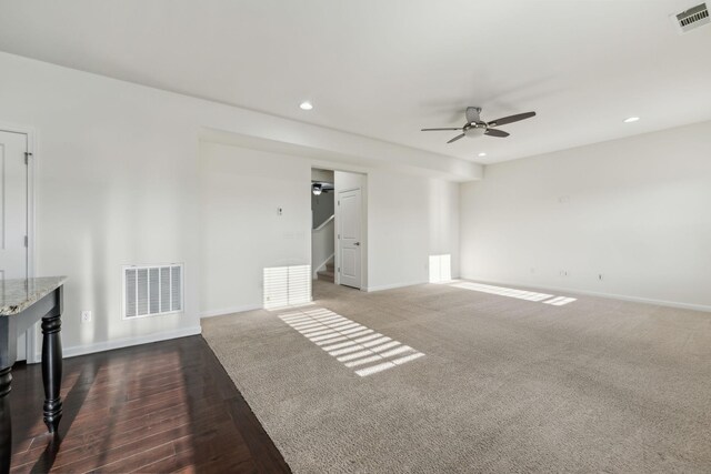 unfurnished living room featuring ceiling fan and dark hardwood / wood-style floors