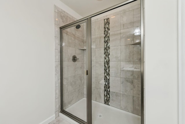 bathroom featuring a shower with shower door